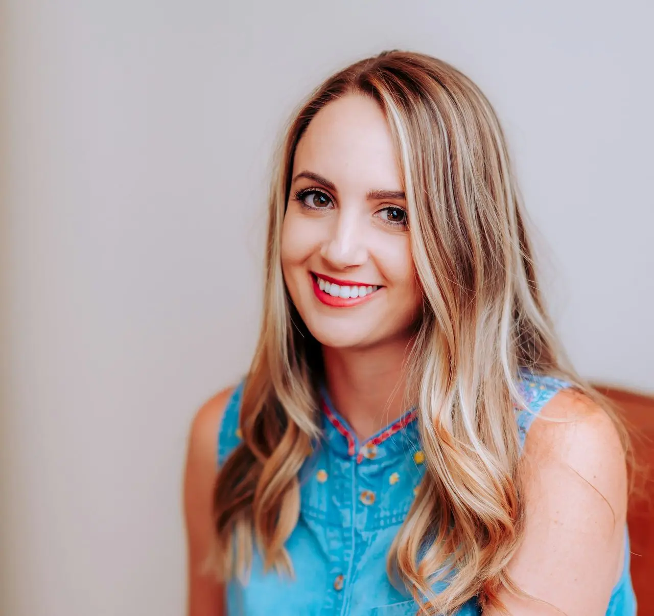 smiling girl in blue sleeveless dress